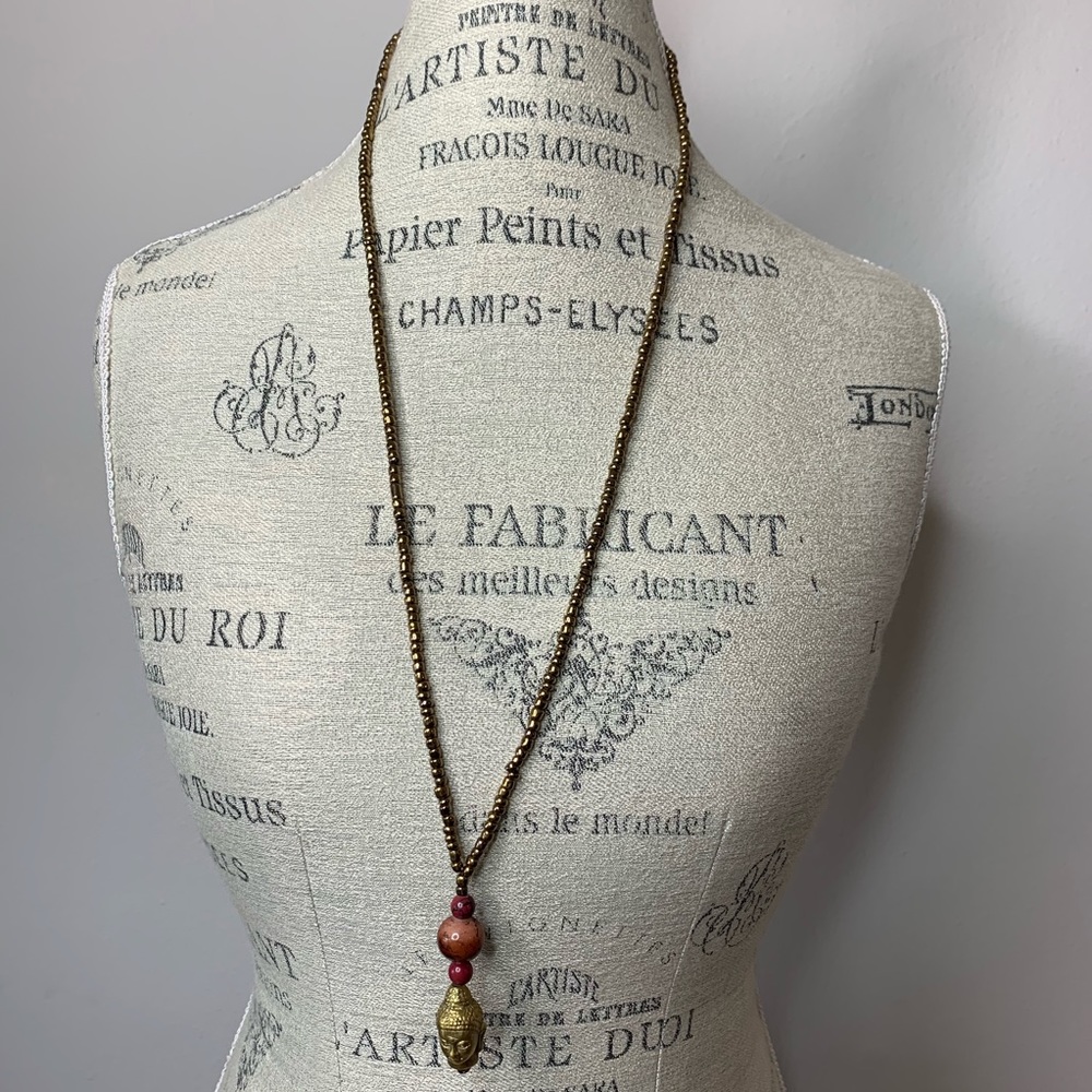 Gold colored necklace with 3 stones